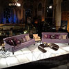 Event design featuring colorful couches on top of lighted stage